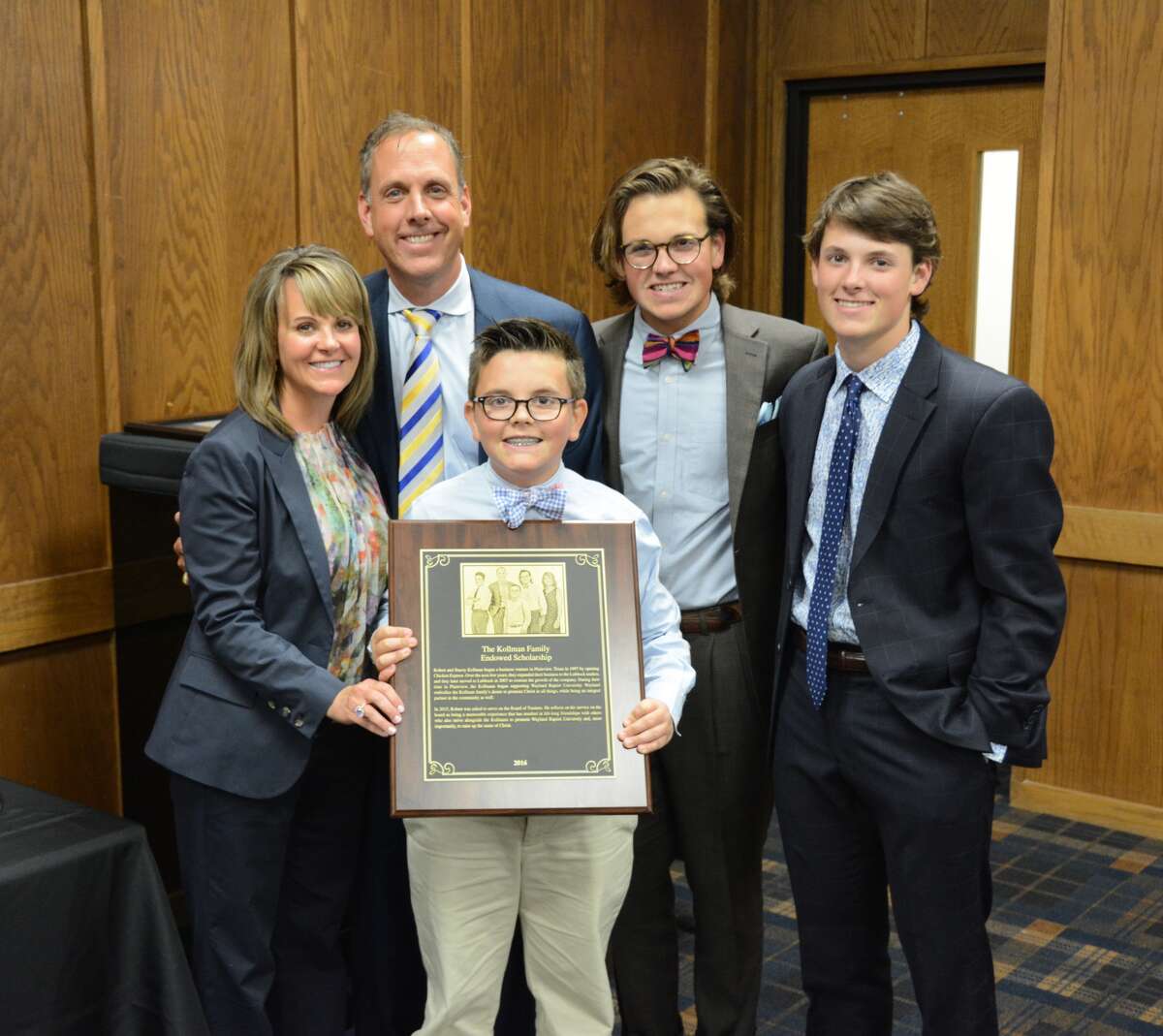 Wayland Board Trustee Robert Kollman and his family were recognized for completing an endowed scholarship that will benefit students in the School of Business. Pictured are Stacey (left), Robert, Deuce (front), Zeke and Eli Kollman.