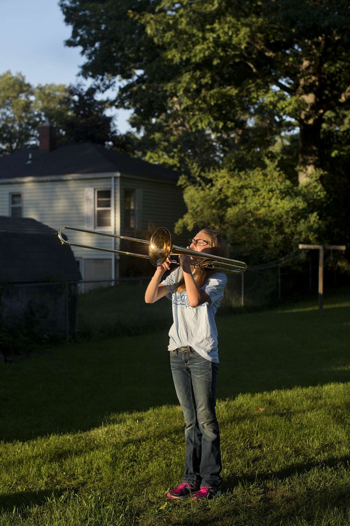 BRITTNEY LOHMILLER | blohmiller@mdn.net Meridian High School freshman Cassidy Forbes practices her trombone in her backyard September 2, 2016 in Sanford. "The band program is what made me want to stay at Meridian," Cassidy said. "We're no know for our sports but our band is good."