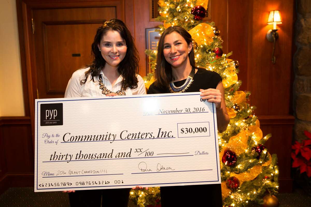Lauren Franciamore and Steviann Martines of Community Centers, Inc. show off the check recieved for winning Pitch Your Peers first annual pitch contest at the Innis Arden Golf Club in Greenwich, Conn on Wednesday, November 30, 2016.