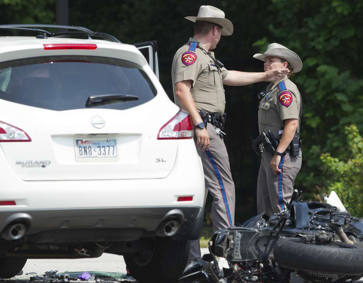 Texas State Troopers investigate the scene of a fatal motorcycle crash near Riley Fuzzel Road and the Grand Parkway, Friday, April 28, 2017, in Spring.