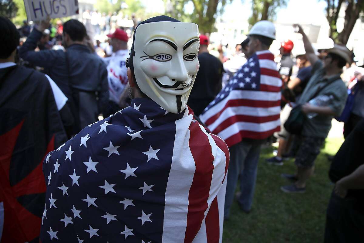 BERKELEY, CA - APRIL 27: Right wing activists wear American flags during a rally at Martin Luther King Jr. Civic Center Park on April 27, 2017 in Berkeley, California. Protestors are gathering in Berkeley to protest the cancellation of a speech by American conservative political commentator Ann Coulter at UC Berkeley. (Photo by Justin Sullivan/Getty Images)