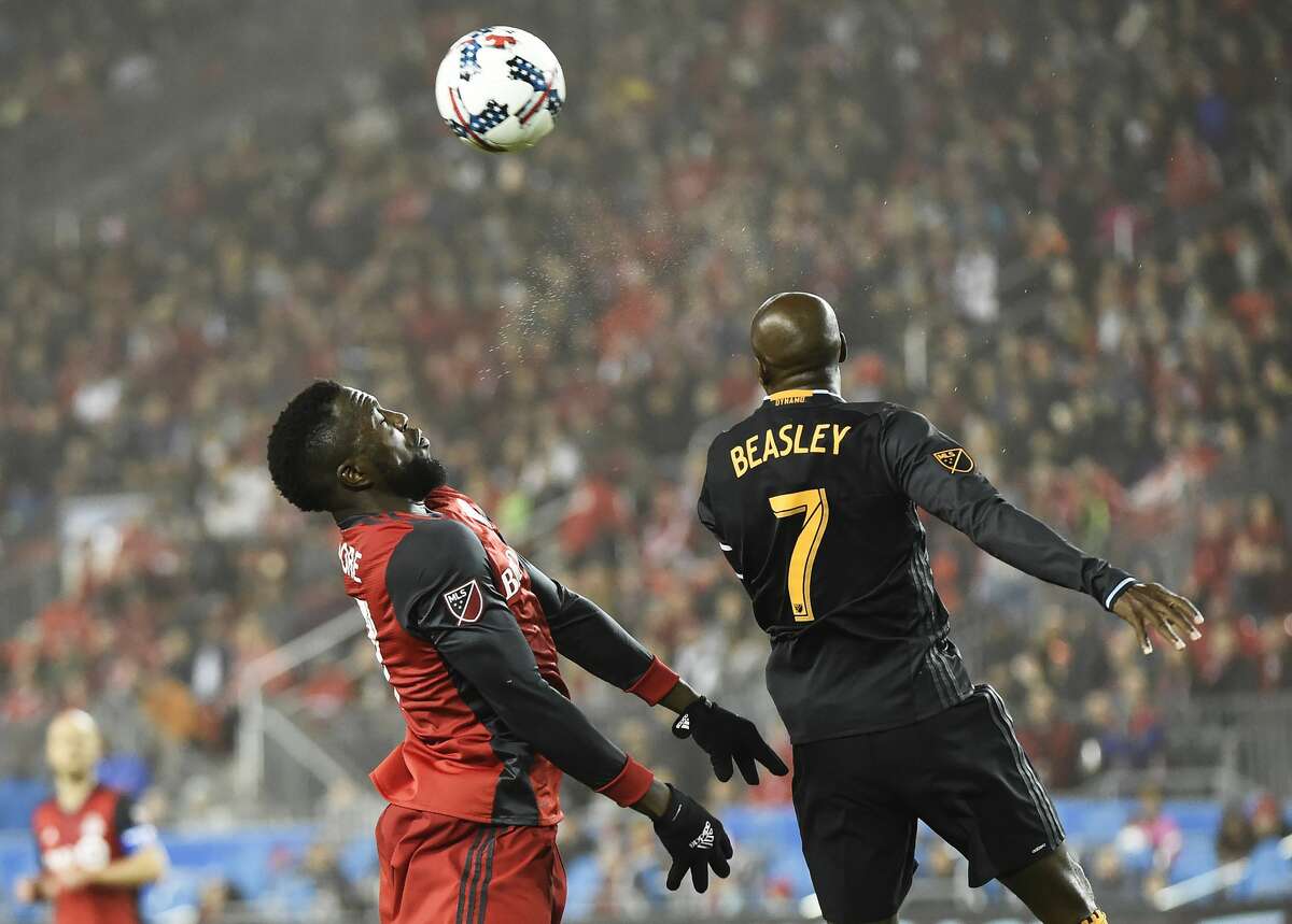 Toronto FC forward Jozy Altidore, left, and Houston Dynamo midfielder DaMarcus Beasley (7) jump for the ball during the second half of an MLS soccer match in Toronto on Friday, April 28, 2017. (Nathan Denette/The Canadian Press via AP)