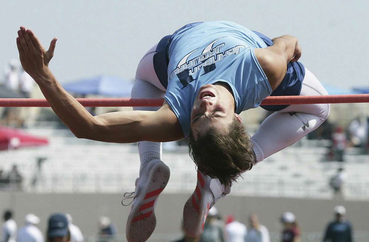Johnson’s Jack Scarborough wraps around the bar in a successful high jump during the Region IV-6A track an field championships at Alamo Stadium on April 28, 2017.