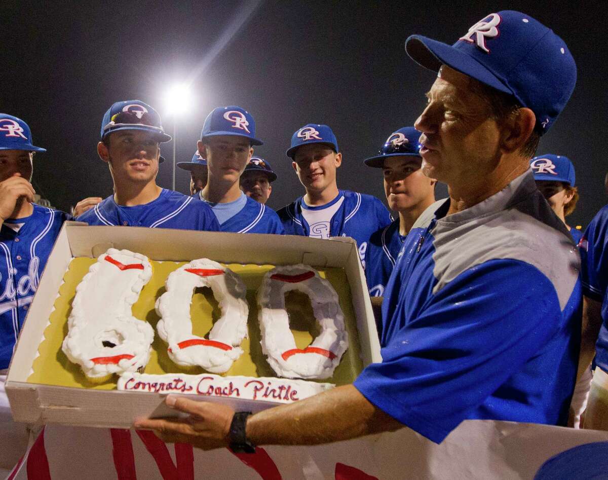Oak Ridge coach Mike Pirtle is seen holding a celebratory cake after winning his 600th game. is seen after the War Eagles defeated Montgomery 8-0 for Pirtle's 600th career win, Friday, April 28, 2017, in Oak Ridge.