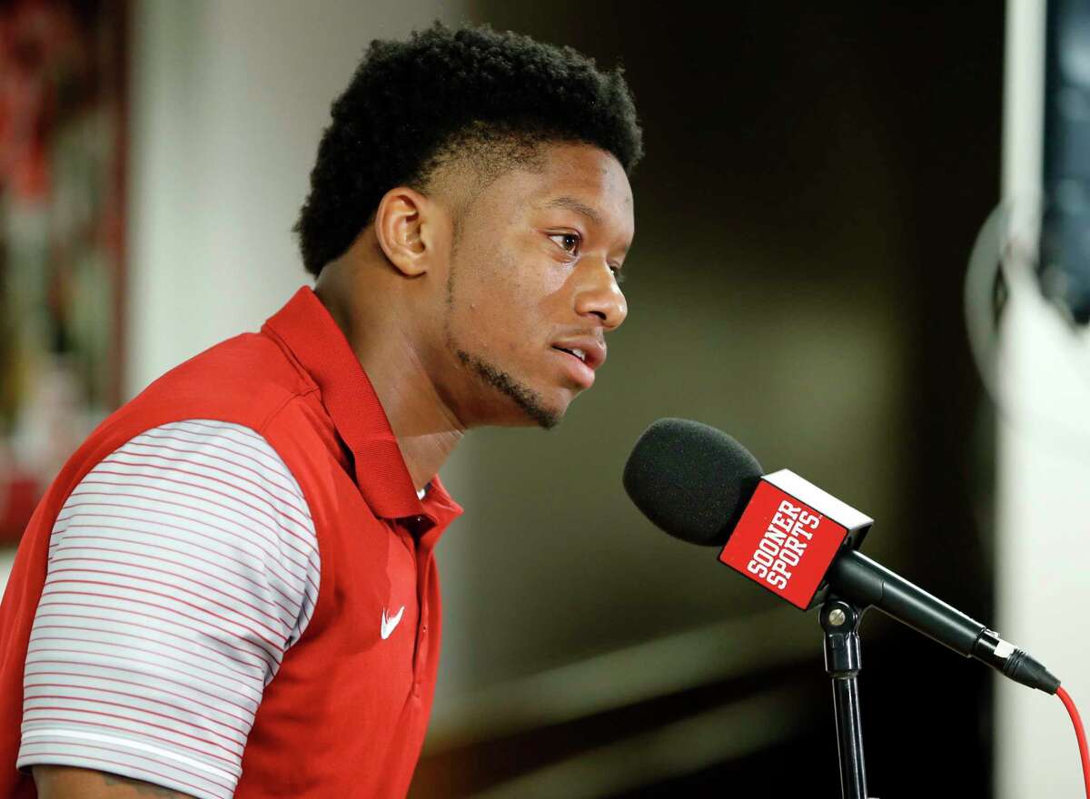 FILE - In this Dec. 23, 2016, file photo, Oklahoma football player Joe Mixon speaks out for the first time since the release of a 2014 video showing him punching a woman in the face, at a press conference in Norman, Okla. Oklahoma receiver Dede Westbrook believes Joe Mixon should be at this week's NFL's scouting combine. Mixon was absent during Friday's, March 3, 2017, running back workouts because a league policy bars players convicted of violent crimes from attending. Mixon and Westbrook were college teammates. (Steve Sisney/The Oklahoman via AP, File)