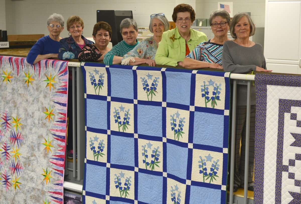 For the 33rd consecutive year, the Creative Quilters will have a large selection of quilts on display at Unger Memorial Library throughout the month of May. The traditional Hanging of the Quilts took place Friday with 21 quilts suspended from the second floor railings. A dozen more are in display cases. Hanging quilts were Emma Rigsby (left), Phil Burns, Bertha Longoria, Ethelyn Vernon, Marsha Allen, Nancy Richburg, Donice Hays and Sandy Bloom. They stand behind a Texas Bluebonnet quilt belonging to Bloom. About 25 years ago, she found the loose quilt blocks at a garage sale on 11th Street. They were crafted in 1936 by a quilting club. With the quilt blocks was a list of club members, including her daughter’s two grandmothers. Donice Hays also is related to members of the 1936 group. The quilt was completed last year – 80 years after it was started. The Creative Quilters will be on hand at the library from 9 a.m. to 2:30 p.m. Monday, May 1, to answer questions and describe the quilts and other items on display.