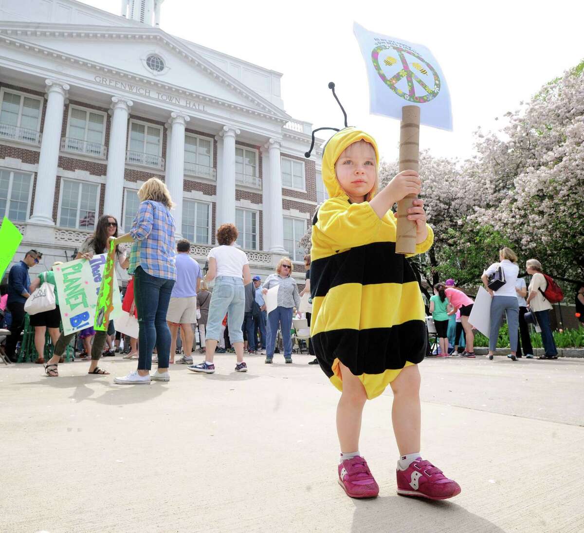 Dressed as a bee, Colleen Cooper, 2, of Cos Cob, holds a sign that says "Give Bees a Chance," during the Children's Environmental March at Greenwich Town Hall, Greenwich, Conn., Saturday morning, April 29, 2017. The gathering of the young environmentalists and their families coincided with the People's Climate March that was taking place in Washington, D.C.