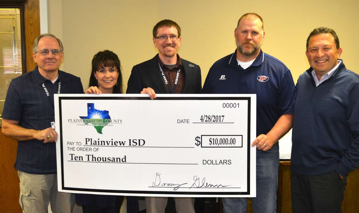 Plainview/Hale County Economic Development Corporation President V.O. Ortega (right) presented a ceremonial $10,000 check to Plainview ISD representatives Friday during the annual board meeting, representing a grant to enhance Career and Technical Education programs. Earlier this month, the initial EDC grant were combined with funding from the Lubbock Economic Development Alliance, Workforce Solutions South Plains and Texas Workforce Commission for a total of $26,908 to PISD to enhance CTE programs. Representing PISD Friday were Jimmy Fikes, Ash High School business teacher; David Haresnape, Plainview High welding instructor; Rob O’Connor, PHS assistant principal; and Robin Straley, director of CTE programs at PISD.