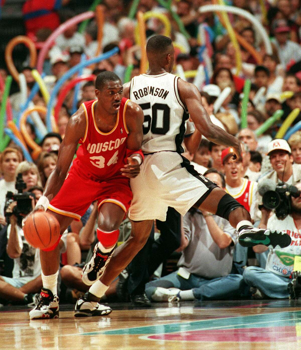 FILE -- DREAM SHAKE -- Hakeem Olajuwon is pictured here doing the famous "dream shake" which caught David Robinson off guard during the playoffs at the Alamodome on 5/24/1995. SPRUS V. ROCKETS -- Photo by Doug Sehres / Staff