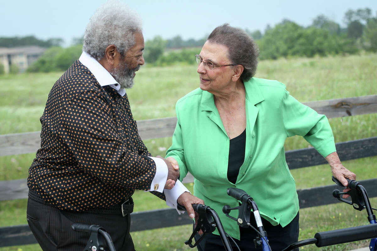 Timothy McWashington, left, and Imogene Giesinger, right, shake hands during the dedication ceremonies for Giesinger and McWashington street signs on Saturday in Montgomery.