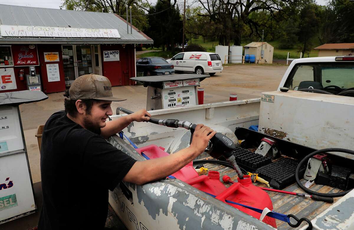 Thomas Godoy who works for a cannabis cultivator, fills up gas cans at Big John's mini mart, to take to the generators that power a cannabis farm in Mountain Ranch, Ca. on Wednesday April 26, 2017.