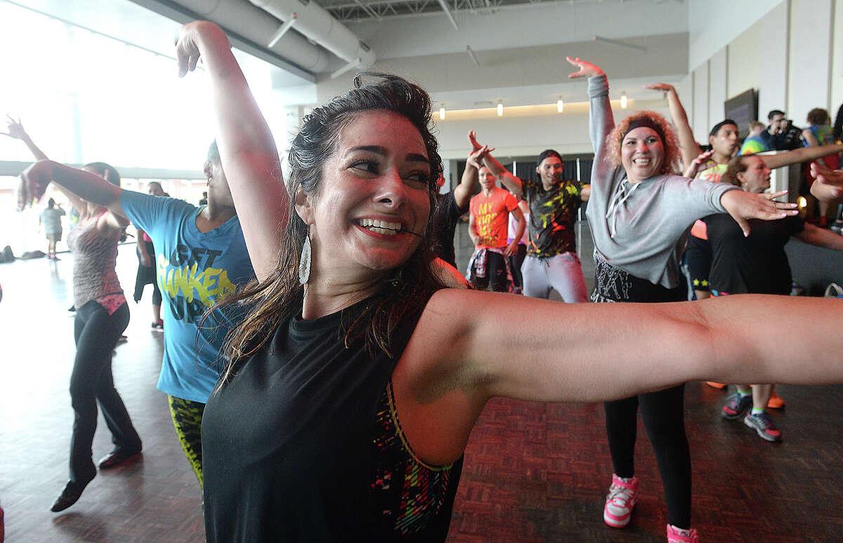 Tracie Robinson and others join in a spirited dance during the "Set the Floor on Fiah" Zumba fitness concert at the Event Centre in Beaumont Sunday. Famous performer Watatah Fiah & DJ Mauricio kept the beats pounding as zumba enthusiasts danced their way to fitness. Proceeds from the event benefitted Child Abuse and Forensic Services, a non-profit organization that treats and offers legal services for abused children and victims of sexual assault. Photo taken Sunday, April 30, 2017 Kim Brent/The Enterprise