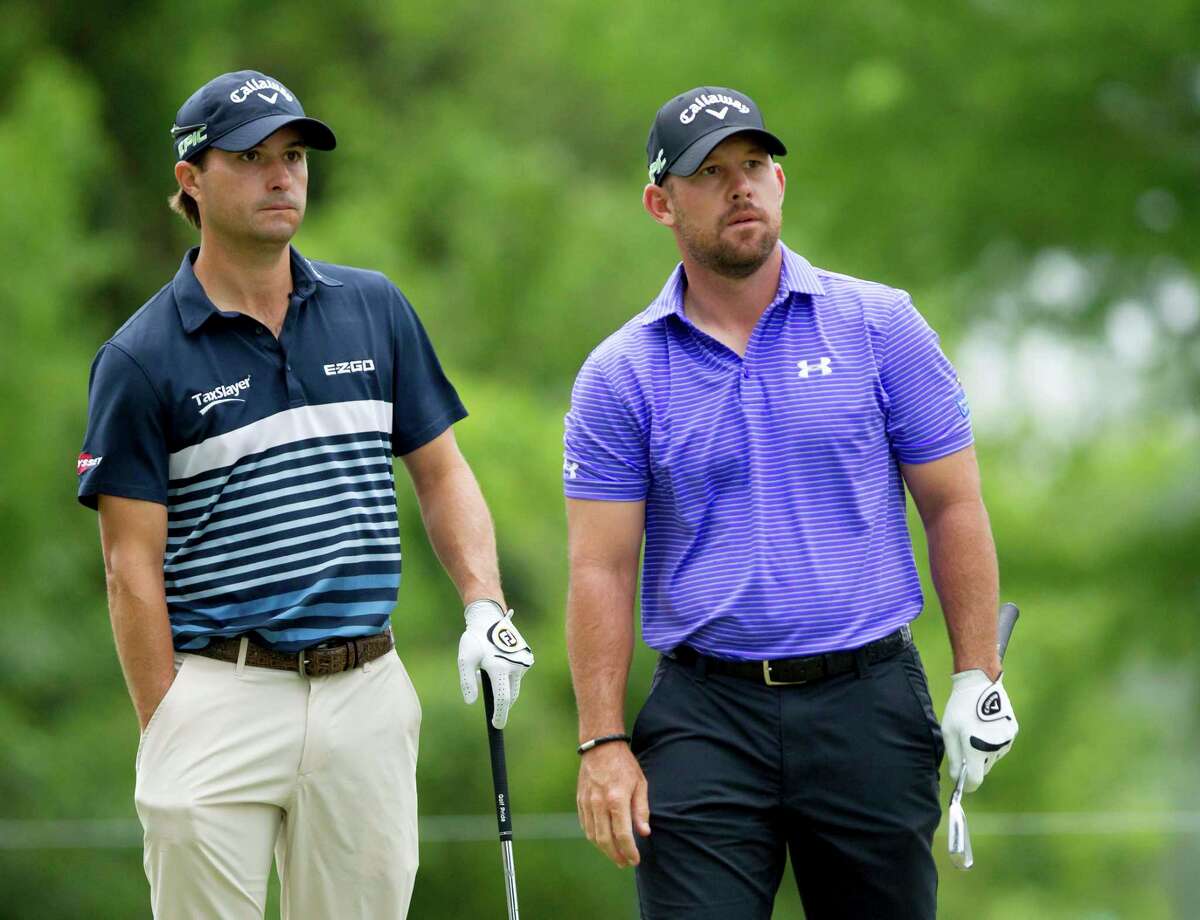 Teammates Kevin Kisner, left, and Scott Brown await their turns to putt on the second hole during the final round of the PGA Zurich Classic golf tournament's new two-man team format at TPC Louisiana in Avondale, La., Sunday, April 30, 2017. (AP Photo/Scott Threlkeld)