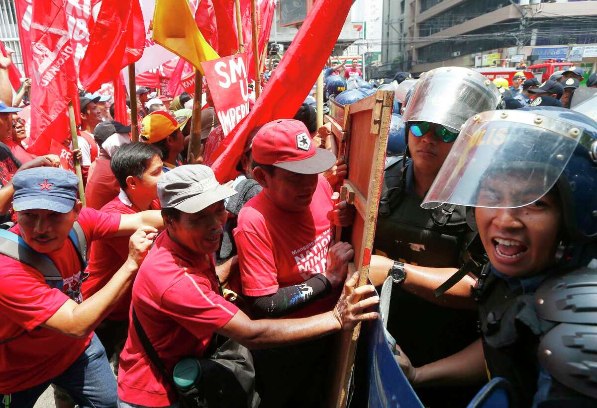 Protesters clash with riot police as they attempt to force their way closer to U.S. Embassy to mark May Day celebrations in Manila, Philippines, Monday, May 1, 2017. As in the past years, workers mark Labor Day with calls for higher wages and an end to the so-called "Endo" or contractualization.