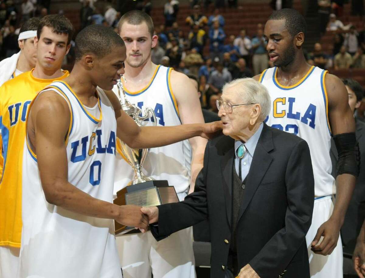 ANAHEIM, CA - DECEMBER 08: Russell Westbrook #0 of the UCLA Bruins shakes hands with John Wooden after a 75-63 win over the Davidson Wildcats during the John Wooden Classic at the Honda Center on December 8, 2007 in Anaheim, California. (Photo by Harry How/Getty Images)