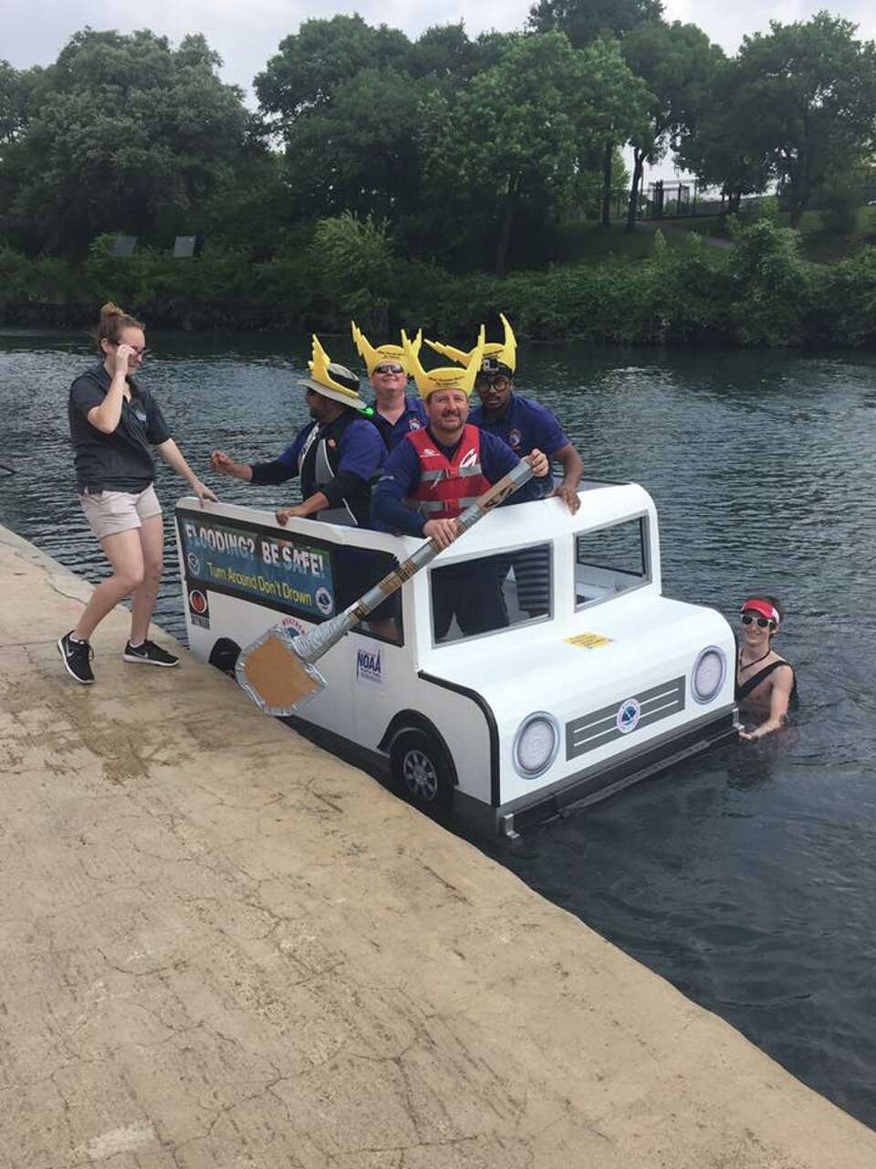Competitors sail New Braunfels Thru the Chute Boat Race as icons
