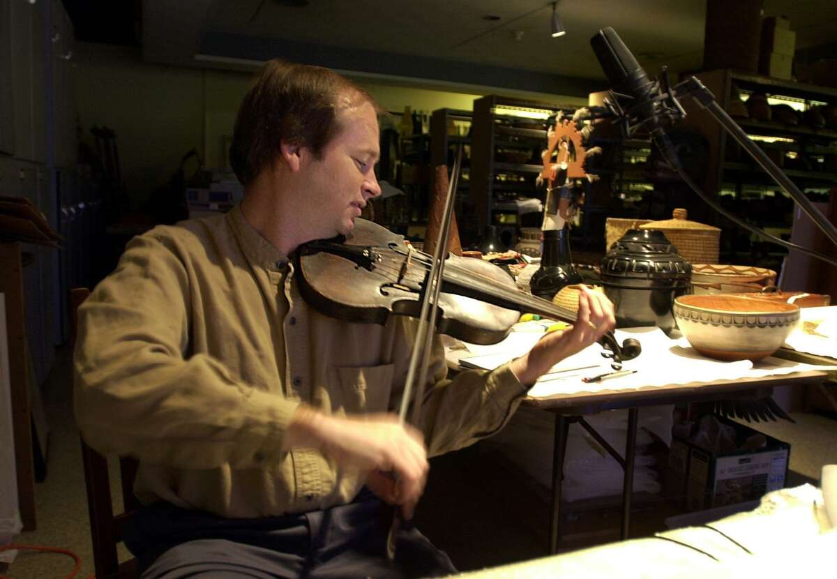 Dean Shostak records a song using what was called Davy Crockett's fiddle Sept. 26, 2001, at the Witte Museum.