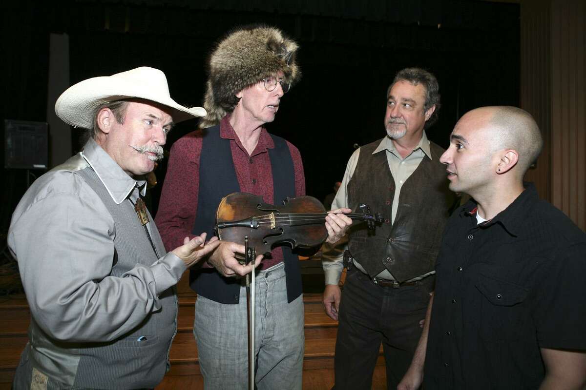 K.R. Wood (CD producer), Mike Fowler (fiddle player holding what was called Crockett's fiddle), T Gosney Thornton (singer) and Rene Gonzales (Witte Museum registrar) were at the Witte Museum on Aug. 17, 2007, for the Davy Crockett 221st Birthday Party and Performance.