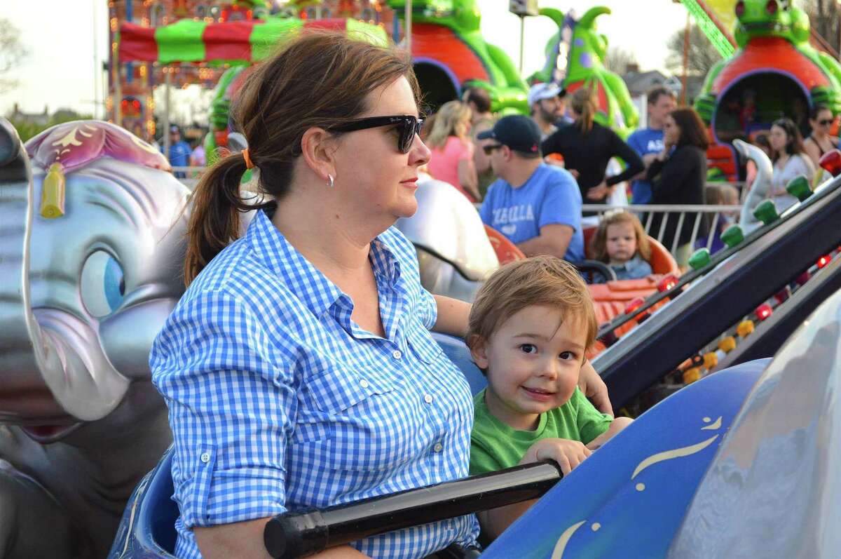 Emily Brakeman of Fairfield and her son, Dylan, 2, take a spin at the McKinley School Carnival at Jennings Beach, Friday, April 28, 2017, in Fairfield, Conn.