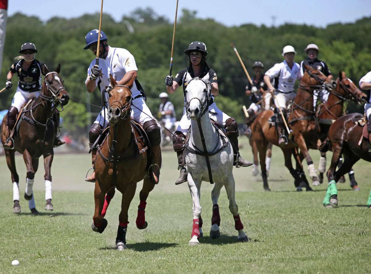 Team King Antonio Ursula Pari MacLeod, (center right) goes up against Team Austin’s Ron Horne during the San Antonio Polo Club's Fiesta King Cup at Olmos Basin Park in 2017.