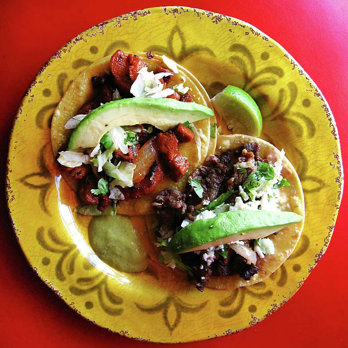 Al pastor, top, and carne asada mini-tacos with lettuce, avocado, cilantro and onions from Isela's Tacos on Culebra Road.