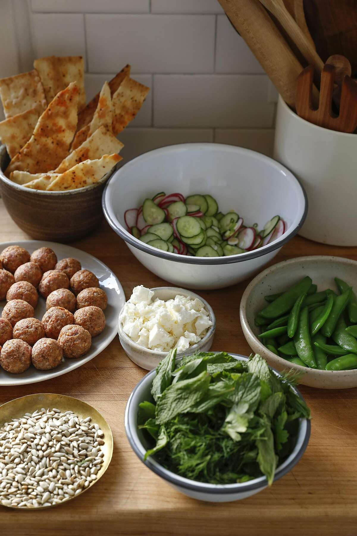 Ingredients for Jessica Battilana's Lamb Meatball Salad, seen on Friday, April 28, 2017 in San Francisco, Calif., include lamb meatballs, left, toasted lavash with Aleppo Pepper, cucumbers, sugar snap peas, Italian flatleaf parsley, dill, mint, toasted sunflower seeds, and feta cheese.