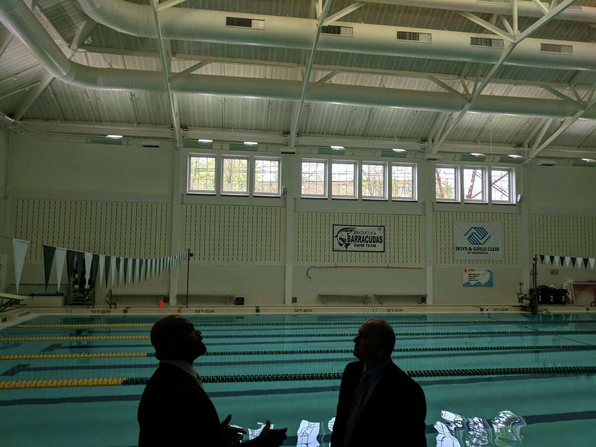 Greenwich Boys and Girls Club Executive Director, Bobby Walker, Jr. (left) and Eversource Energy Efficiency Manager Ron Araujo (right) talking at the Monday tour of Eversource’s energy-efficiency upgrades at the club. New lighting at the pool — in a room that was originally very dim despite being open as early as 6 a.m. daily — has made it safer and been able to offer a better experience for swimmers, according to Walker and Araujo. May 1, 2017.