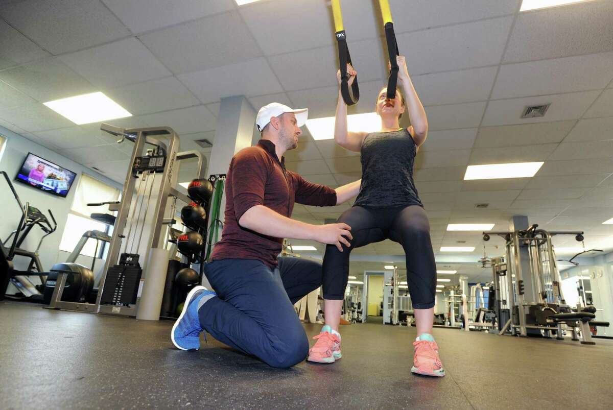 At left, Anel Dzafic, the founder of Countdown Fitness, works-out client Lauren Argenti at Rick Stebbins Performance Therapy Center in Greenwich, Conn., Friday night, April 28, 2017. Dzafic will open his own studio at 409 Greenwich Ave. in September 2018.