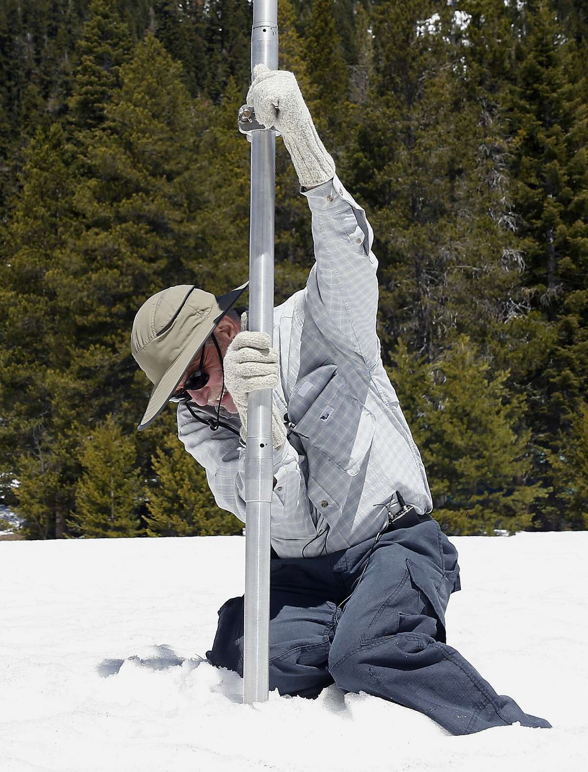 Frank Gehrke, chief of the California Cooperative Snow Surveys Program for the Department of Water Resources, plunges the snow survey tube into the snow pack, during the snow survey at Phillips Station, Monday, May 1, 2017, near Echo Summit, Calif. (AP Photo/Rich Pedroncelli)