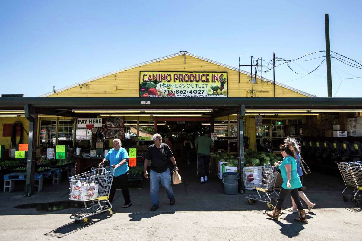 Shoppers walk outside Canino Produce Inc., Farmers Outlet in the 2500 block of Arline on Monday, May 1, 2017, in Houston. A local developer is under contract to purchase the farmer's market property in the Heights area. The group says the market will stay, but improvements are planned that will affect the property in the long term. ( Brett Coomer / Houston Chronicle )