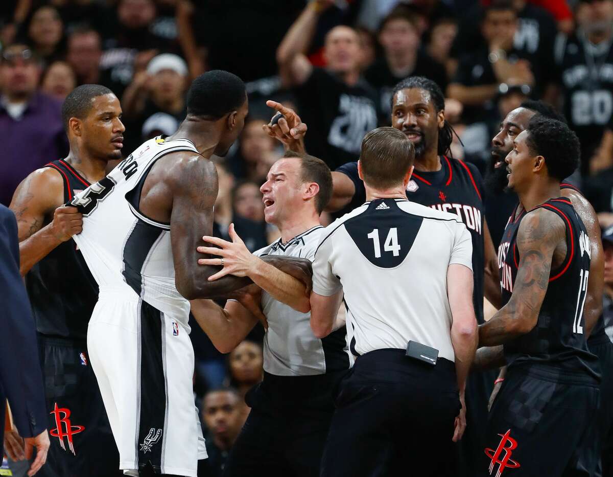 Officials try to create space during an altercation between San Antonio Spurs center Dewayne Dedmon (3) and Houston Rockets center Nene (42) during the second half of Game 1 of the second-round of the Western Conference NBA playoffs at AT&T Center, Monday, May 1, 2017, in San Antonio. Houston Rockets center Nene (42) was ejected from the game for putting his hand on San Antonio Spurs center Dewayne Dedmon's (3) throat. ( Karen Warren / Houston Chronicle )