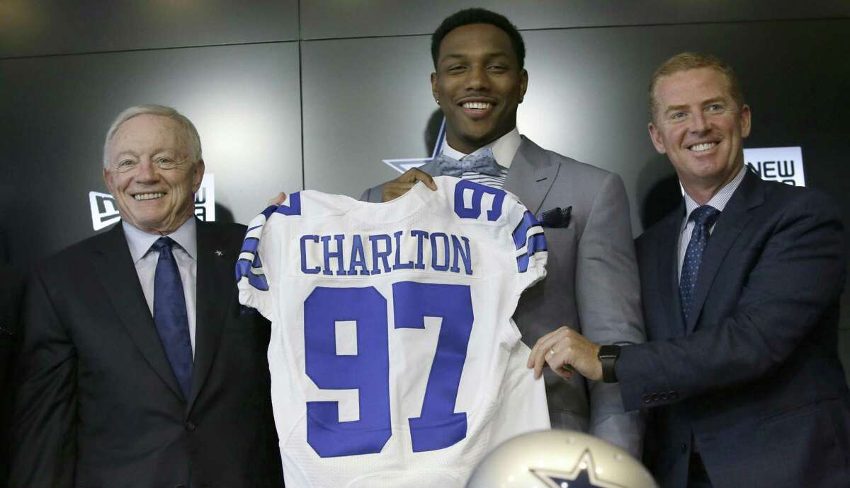 The Dallas Cowboys No. 1 draft pick defensive end Taco Charlton, center, poses for a photos with team owner Jerry Jones, left, and head coach Jason Garret during a news conference at the team's football headquarters in Frisco, Texas, Friday, April 28, 2017.