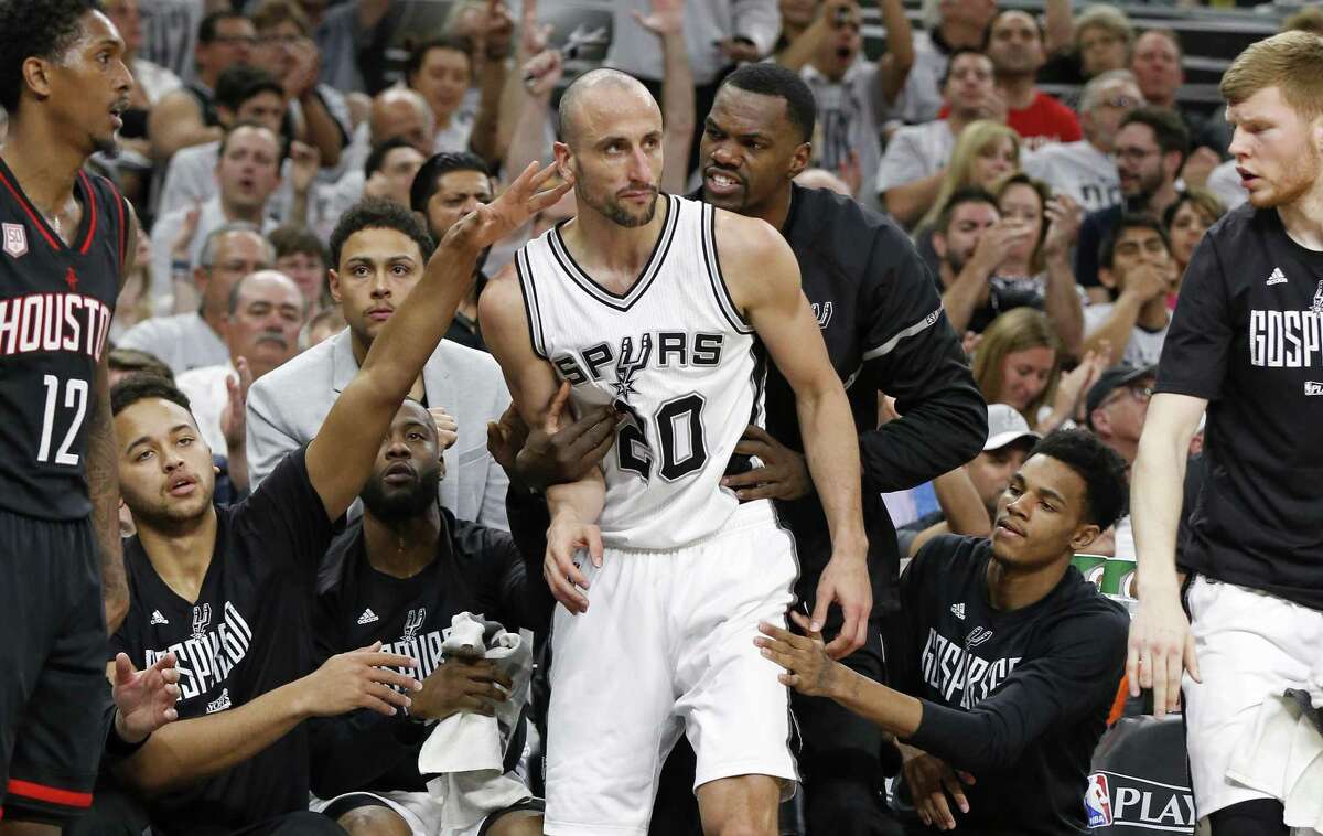 Manu Ginobili winds up in the Spurs’ bench after a 3-pointer.