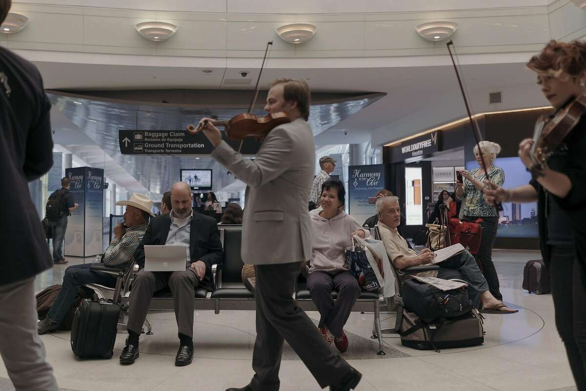 Members of the Apollo Chamber Players perform for travelers at Hobby Airport in Houston, March 28, 2017. A growing number of airports across the country are welcoming musicians to perform in the hopes of easing anxiety — and generating more revenue. (Todd Spoth/The New York Times)