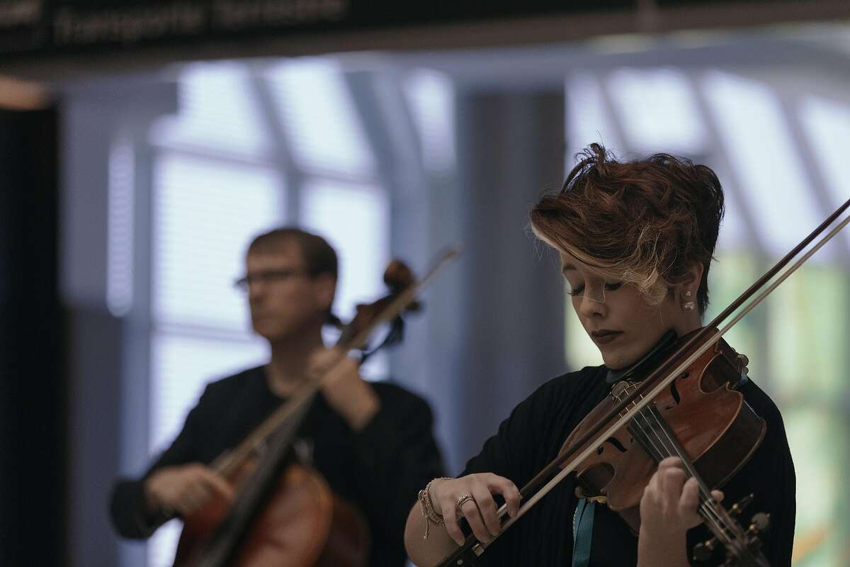 Whitney Bullock performs with the Apollo Chamber Players for travelers at Hobby Airport in Houston, March 28, 2017. A growing number of airports across the country are welcoming musicians to perform in the hopes of easing anxiety � and generating more revenue. (Todd Spoth/The New York Times)