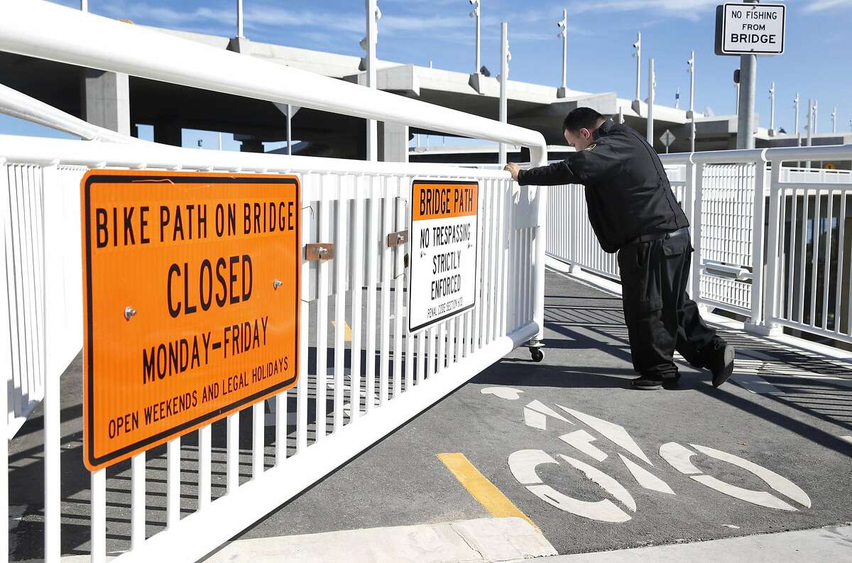 Jesse Flores pushes a gate to open the Bay Bridge Bike Path on Yerba Buena Island in San Francisco, Calif. on Tuesday, May 2, 2017. Transportation officials dedicated a new vista point overlooking the new eastern span and the East Bay on the same day the 2.2 mile bike and pedestrian path opened on weekdays making it accessible 7 days a week.