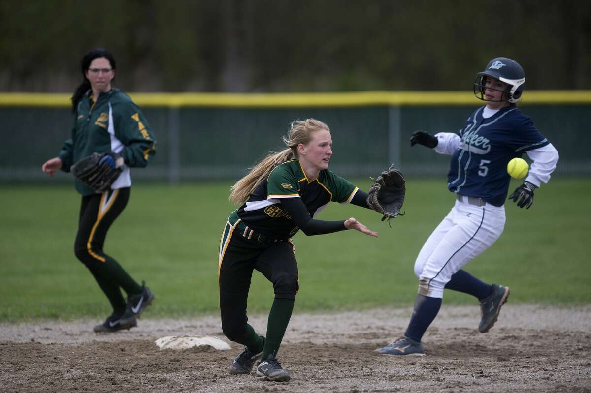 Dow High's Krista Moe catches the ball to try and force out Lapeer runner Ally Brown in the third inning of the Tuesday afternoon game.