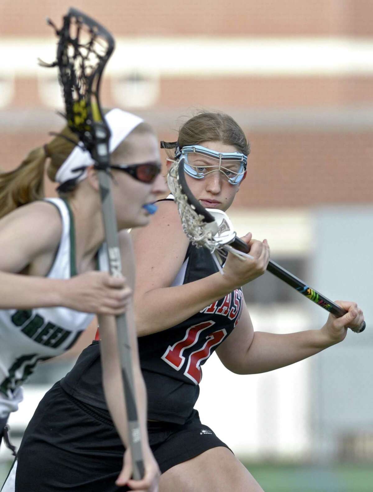 Masuk's Samantha Sebben (12) defends New Milford's Kelli Souza (18) as she races up field with the ball in the girls lacrosse game between Masuk and New Milford high schools, on Tuesday night, May 2, 2017, at New Milford High School, in New Milford, Conn.