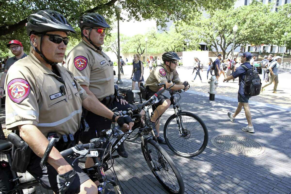 State Troopers (from left) Tony Ricco, Gabriel Macias and Guy Hoffman watch foot traffic on campus as extra police presence is noticeable on the University of Texas campus near Gregory Gym on Tuesday, May 2, 2017, one day after a wild stabbing spree took place at the scene.