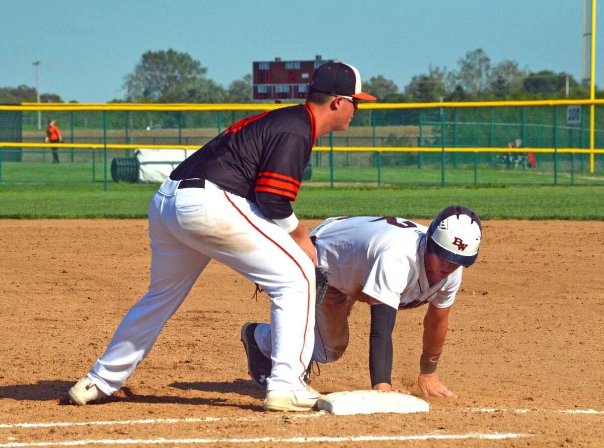 Edwardsville first baseman Drake Westcott, left, puts the tag on Belleville West’s Logan Betz on an attempted pickoff during the second inning of Tuesday’s game at Belleville West.
