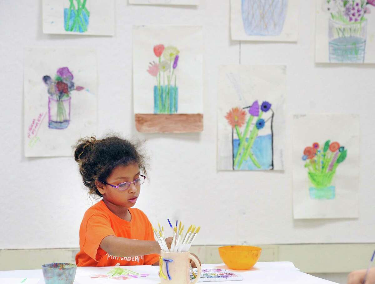 Gabriela Aliaga, 8, works on a still life watercolor painting of flowers in the recently renovated art room at the Boys & Girls Club of Greenwich, Conn., Tuesday, May 2, 2017. The renovation was done in a collaboration between the Junior League of Greenwich Class of 2016-2017 and the Boys & Girls Club.