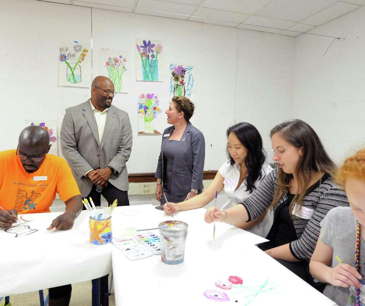 Standing at back left, Bobby Walker Jr., chief executive offiicer of the Boys & Girls Club of Greenwich, speaks with Sue Moretti Rogers (back right), president of the Junior League of Greenwich, in the recently renovated art room at the Boys & Girls Club of Greenwich, Conn., Tuesday, May 2, 2017. The renovation was done in a collaboration between the Junior League of Greenwich Class of 2016-2017 and the Boys & Girls Club.