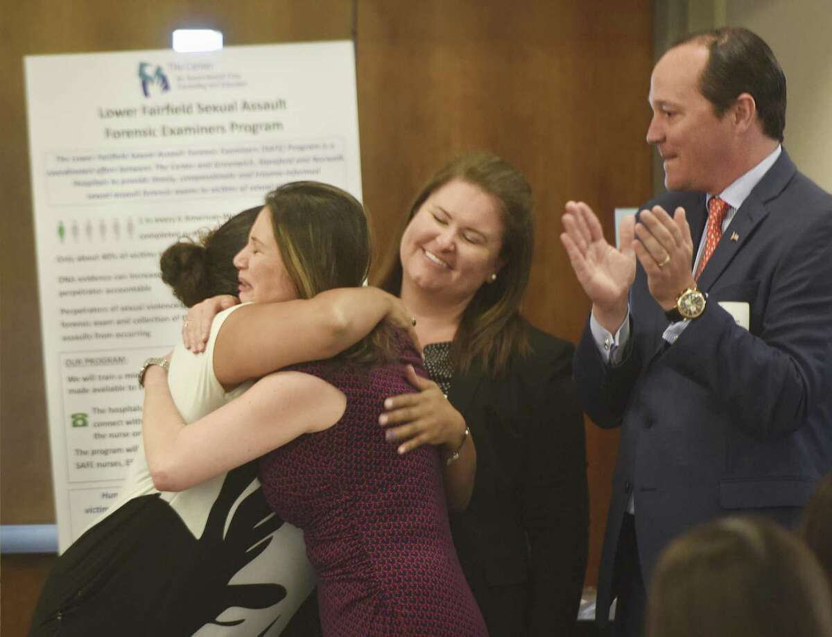 Sexual Assault Crisis and Education Center Executive Director Ivonne Zucco hugs Michelle Vincoli, left, as fellow team members Sarah Gleason and Clifton Benham celebrate The Center's $100,000 grant awarded for the Sexual Assault Forensic Examiners (SAFE) Program at Impact Fairfield County's Grant Awards Presentation at the UConn Stamford campus in Stamford, Conn. Wednesday, May 3, 2017. The Sexual Assault Crisis and Education Center won a $100,000 grant for its Sexual Assault Forensic Examiners (SAFE) Program, which will coordinate between The Center and Greenwich, Stamford and Norwalk Hospitals to provide expedited and compassionate sexual assault forensic exams to victims of sexual violence.
