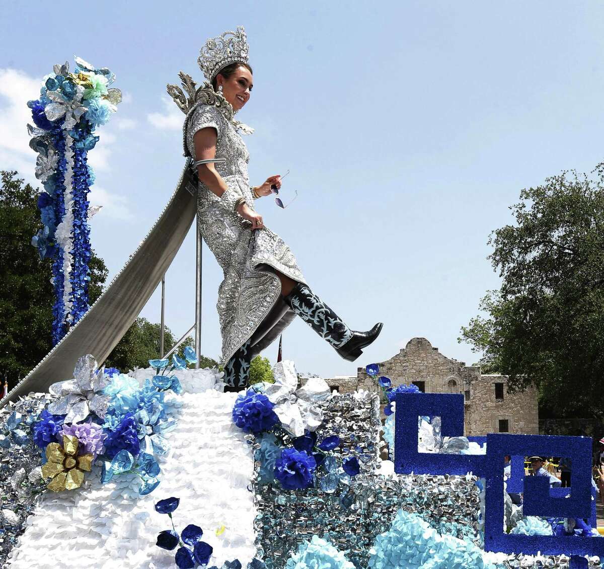 Frances Carolina Roberts, Princess of the Splendors of the Rio de la Plata, shows her boots for the crowd as her float passes by the Alamo during the 2017 Battle of Flowers parade on Friday, Apr. 28, 2017. (Kin Man Hui/San Antonio Express-News)
