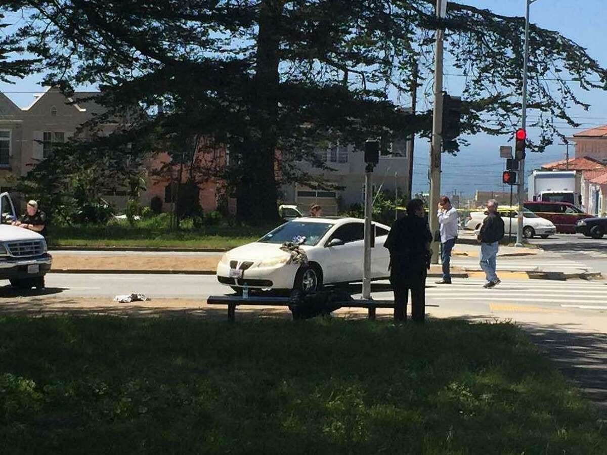 A 15-year-old boy fatally shot while driving this white Pontiac in the Outer Sunset District on Monday was identified by authorities Tuesday as Reajohn Jackson of Daly City.