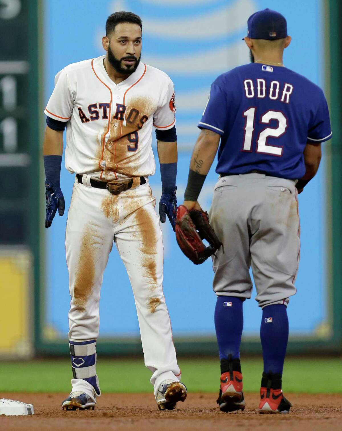 Houston Astros Marwin Gonzalez talks to Texas Rangers Rougned Odor as he dusts himself off after hitting a double during the second inning at Minute Maid Park Wednesday, May 3, 2017, in Houston.