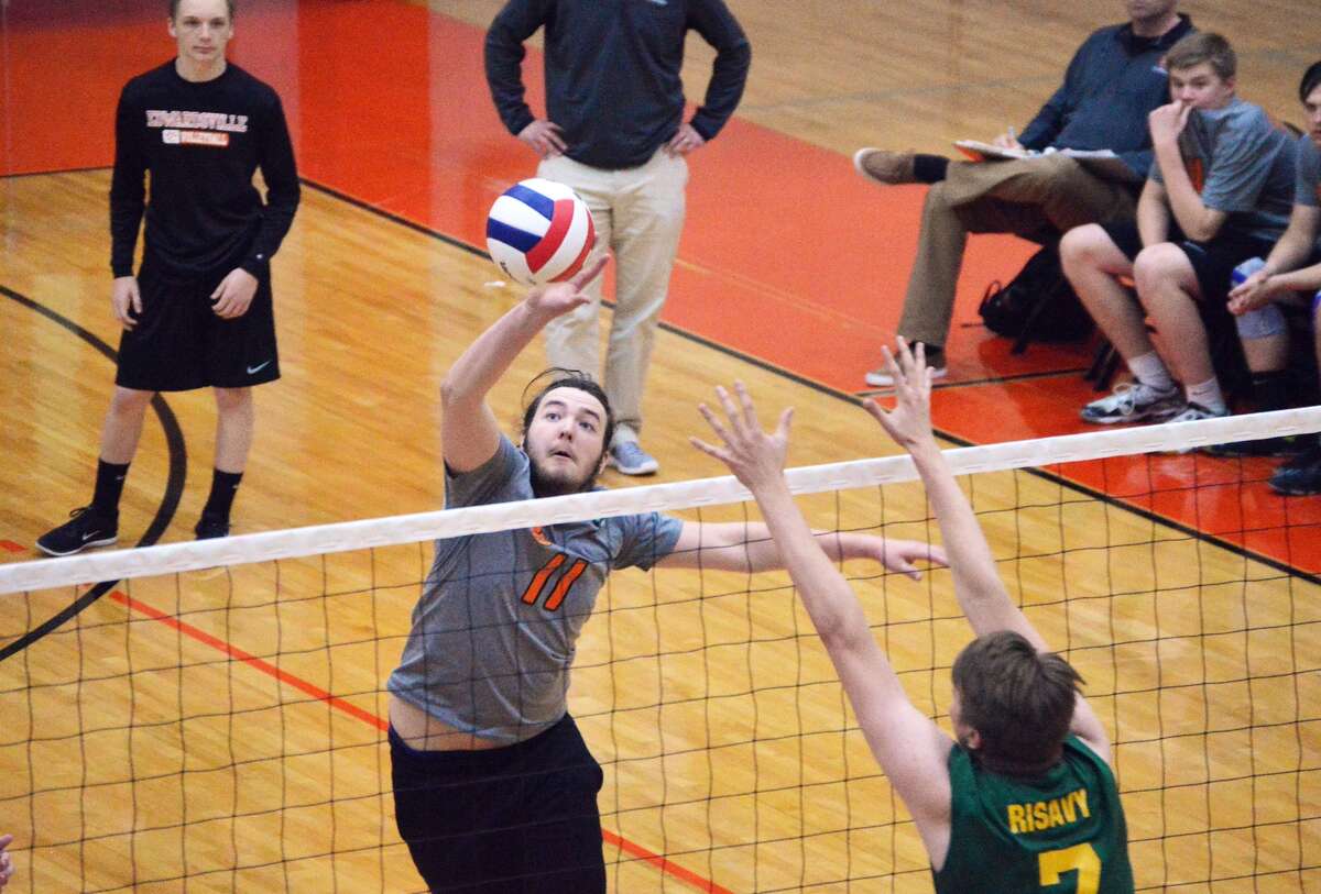 Edwardsville middle senior Will Bode, left, tips a ball past Metro-East Lutheran blocker A.J. Risavy during first-game action Wednesday inside Lucco-Jackson Gymnasium.