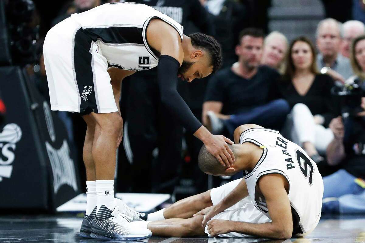 San Antonio Spurs guard Patty Mills (8) puts his hand on guard Tony Parker's (9) head after he was injured during the second half of Game 2 of the second-round of the Western Conference NBA playoffs at AT&T Center, Wednesday, May 3, 2017, in San Antonio.