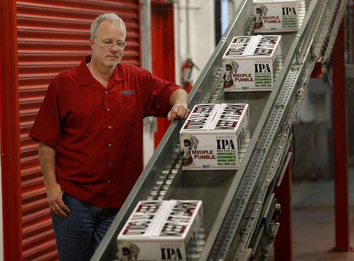 Lagunitas Brewing CEO Tony Magee watches cases come off the bottling line in Petaluma, Calif. Craft brew sensation Lagunitas Brewing Company has dropped its trademark infringement lawsuit against fellow brewer Sierra Nevada Brewing Wednesday January 14, 2015.