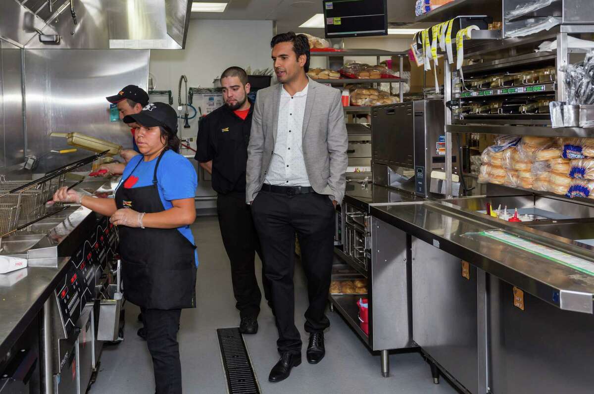 May 3, 2017: General manager Juan Mora guides Kamal Singh through the kitchen of the Sonic store located near the University of Houston-Clear Lake in Houston, Texas. (Leslie Plaza Johnson/Freelance)